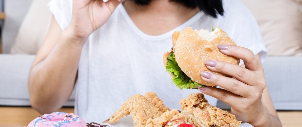 Eine Frau vor viel Fastfood